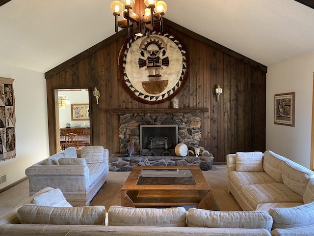 living room with carpet floors, a stone fireplace, a notable chandelier, and wood walls