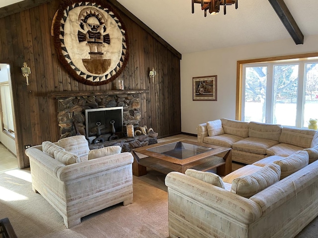 carpeted living room featuring lofted ceiling with beams, wood walls, and a stone fireplace