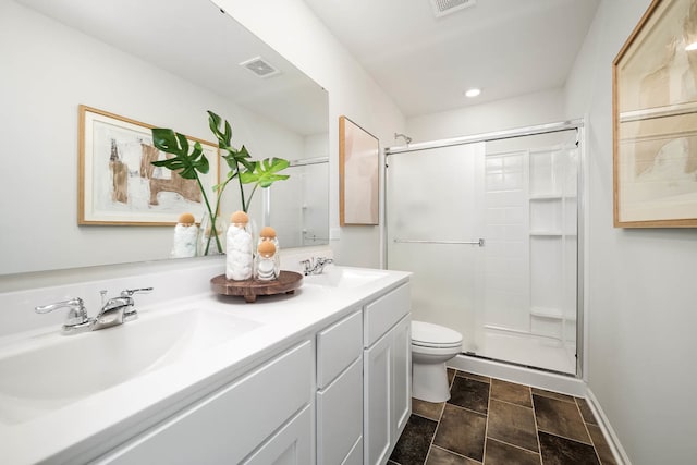 bathroom with vanity, toilet, and an enclosed shower