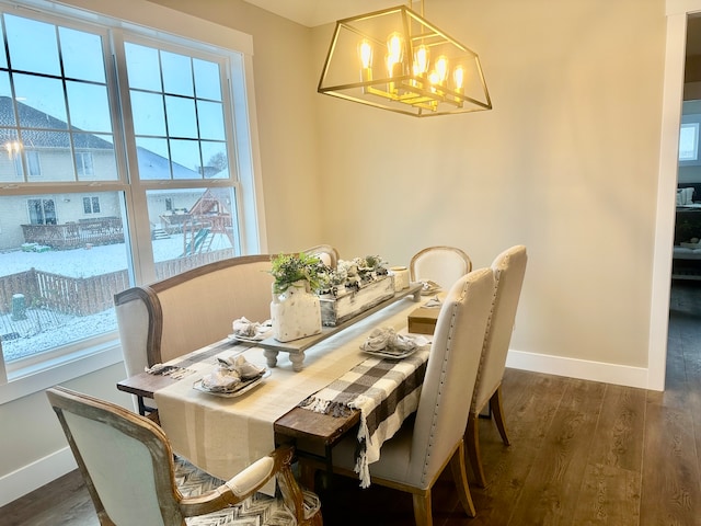 dining area with a notable chandelier and dark wood-type flooring