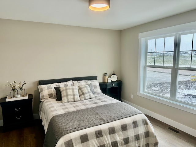 bedroom with dark wood-type flooring