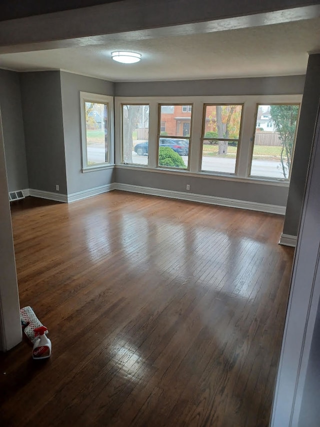 empty room with hardwood / wood-style floors