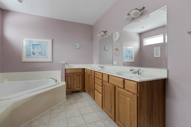 bathroom featuring tile patterned floors, vanity, and a tub to relax in