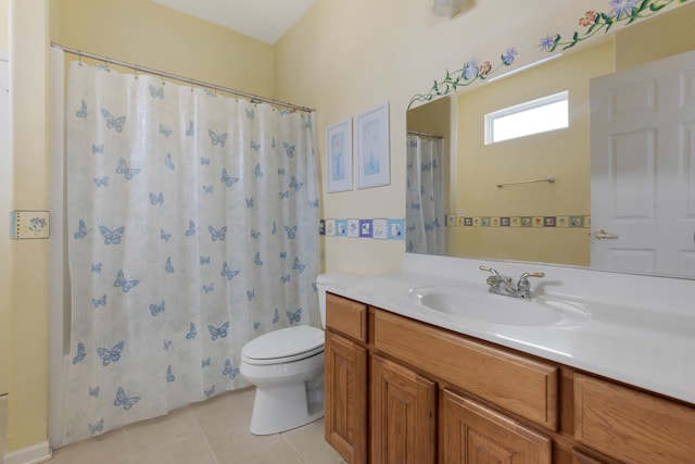 bathroom featuring toilet, vanity, tile patterned floors, and a shower with shower curtain