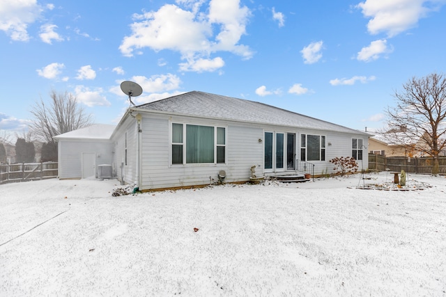 snow covered house with central air condition unit