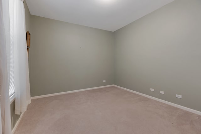 spare room with light colored carpet