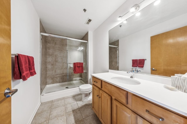 bathroom with toilet, vanity, tile patterned floors, and walk in shower