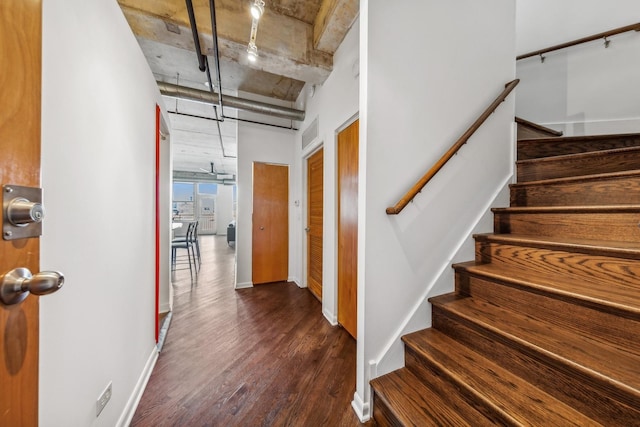 staircase with wood-type flooring