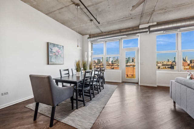 dining space featuring a healthy amount of sunlight and dark hardwood / wood-style flooring