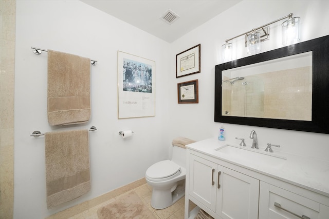 bathroom featuring tile patterned floors, vanity, toilet, and tiled shower