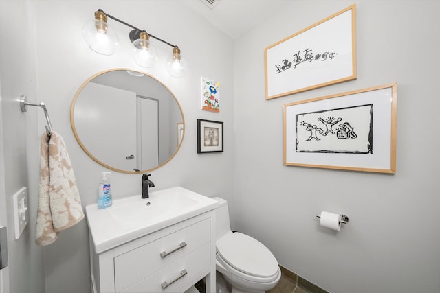 bathroom featuring tile patterned floors, vanity, and toilet