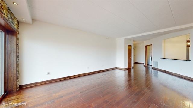 spare room with dark hardwood / wood-style flooring