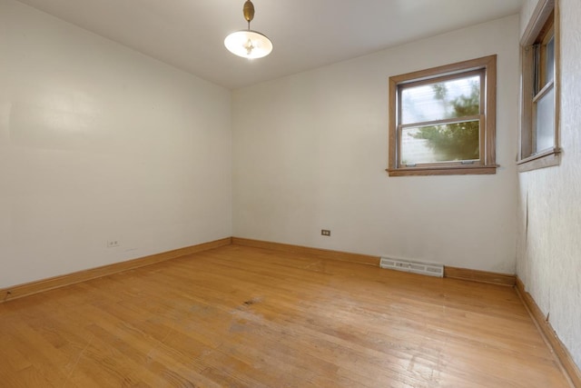 empty room with light hardwood / wood-style flooring