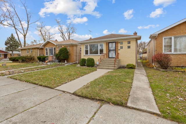 bungalow-style home with a front yard