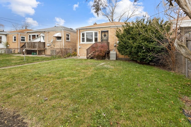 view of front of home featuring central AC and a front lawn