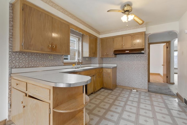 kitchen with ceiling fan, sink, and custom exhaust hood