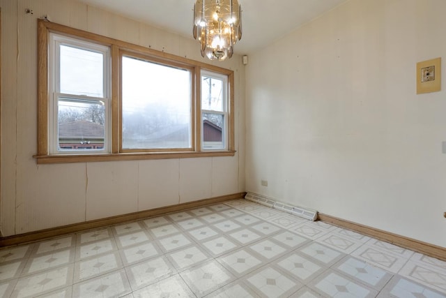 unfurnished room with a chandelier