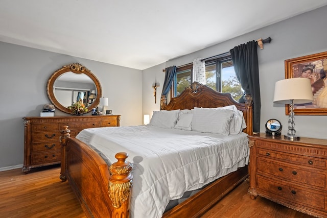 bedroom with hardwood / wood-style flooring