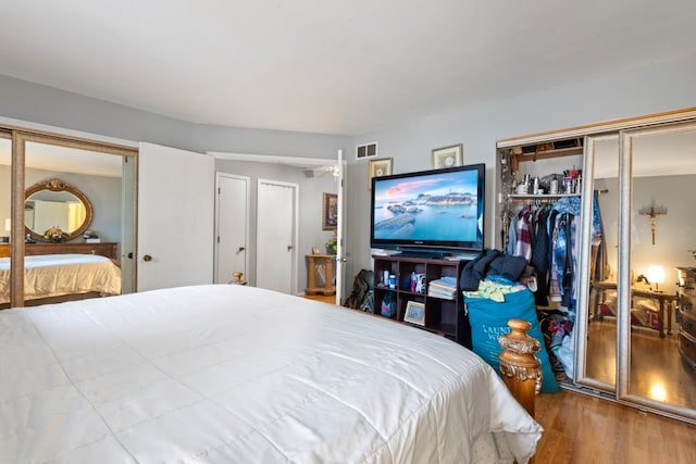 bedroom with hardwood / wood-style floors and a closet