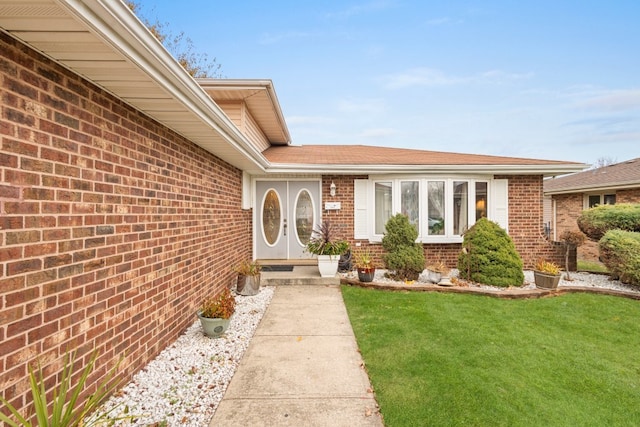 property entrance with a yard