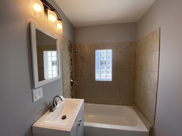 bathroom with vanity and tiled shower / bath