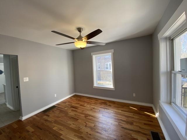 unfurnished room featuring ceiling fan and dark wood-type flooring