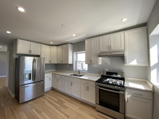 kitchen with light hardwood / wood-style flooring, stainless steel appliances, white cabinetry, and sink