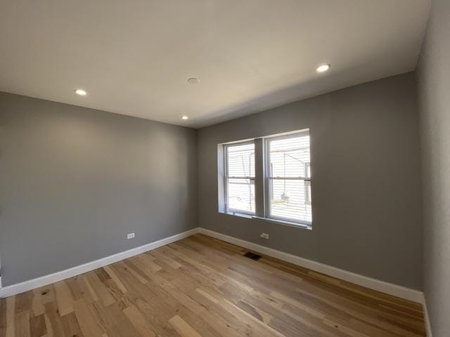 unfurnished room with light hardwood / wood-style floors