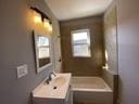 bathroom with vanity and a tub to relax in