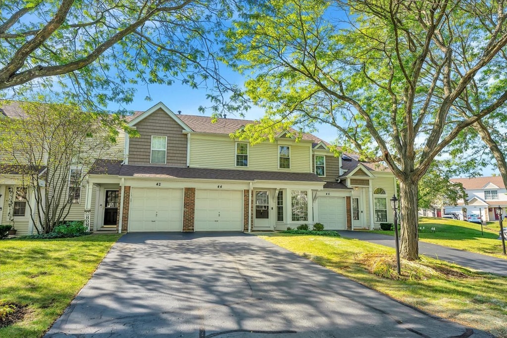 view of front of home with a front lawn and a garage