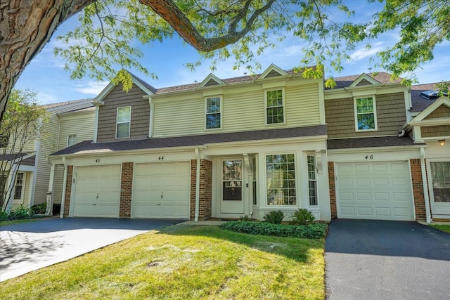 view of property featuring a front yard and a garage