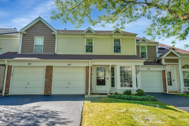 view of property featuring a garage and a front yard