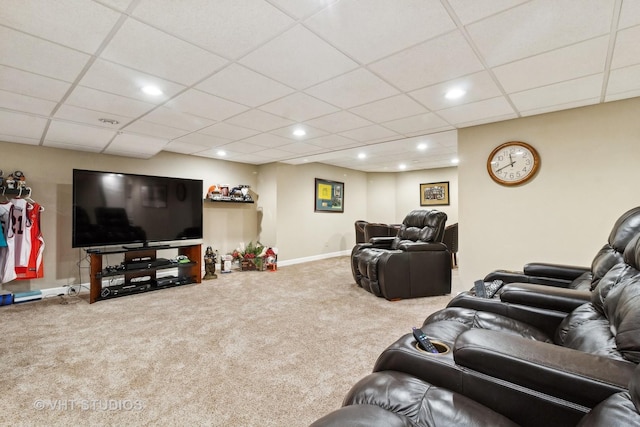 carpeted living room with a paneled ceiling