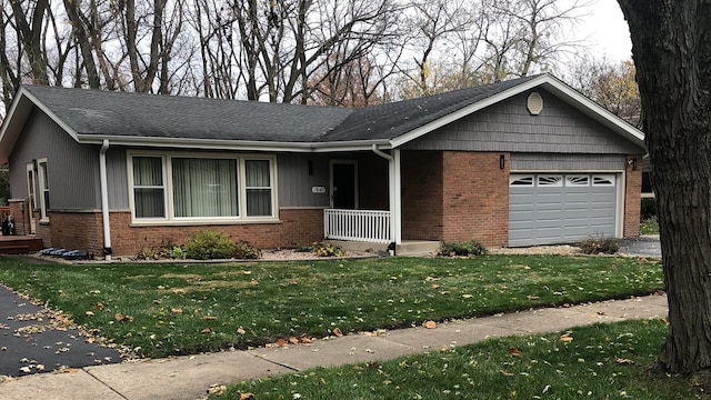 single story home with a porch, a garage, and a front lawn