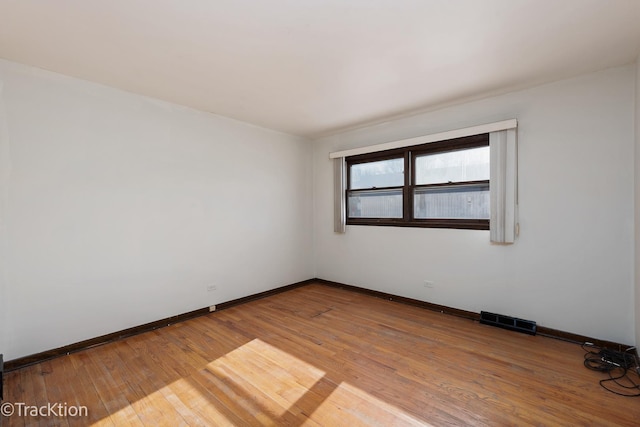 spare room featuring hardwood / wood-style flooring