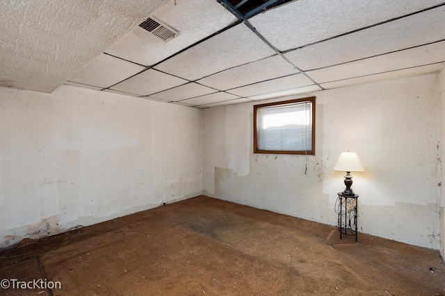 basement with a paneled ceiling