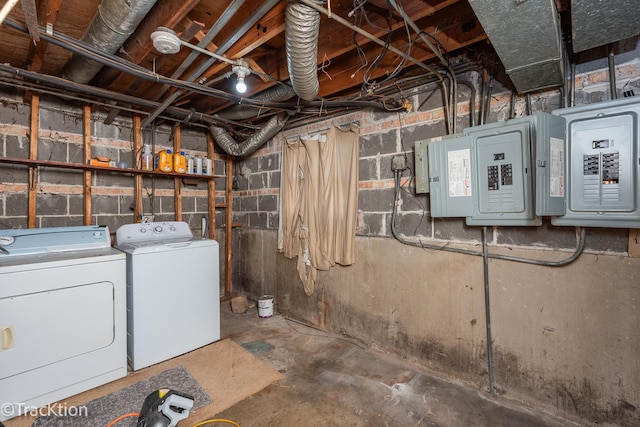 basement with washing machine and dryer and electric panel