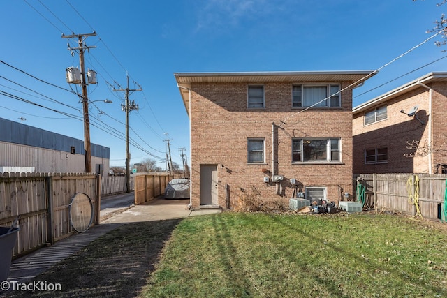 rear view of property with a lawn