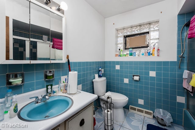 full bathroom with toilet, bath / shower combo with glass door, tile walls, vanity, and tile patterned flooring