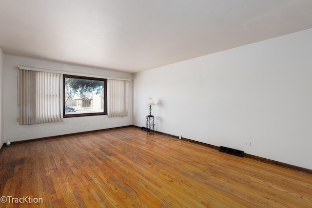 unfurnished room with wood-type flooring