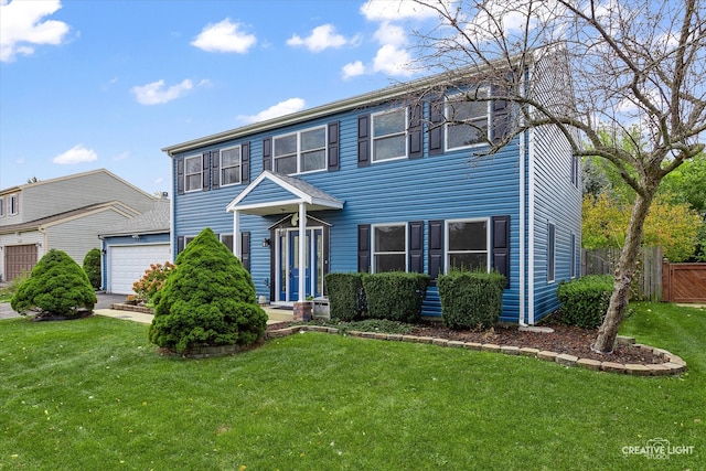 colonial home with a front yard and a garage