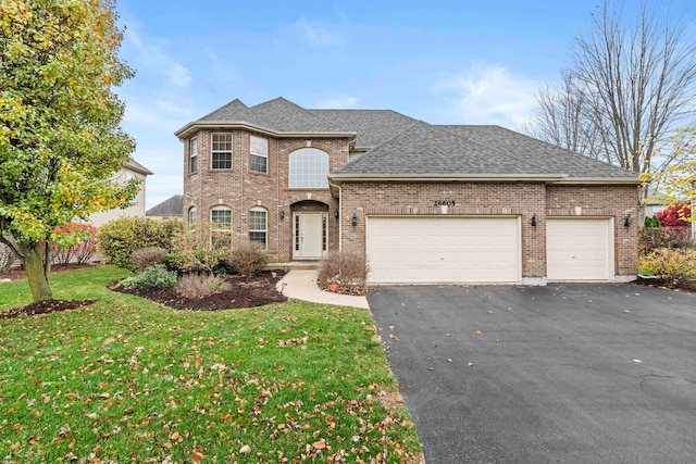 view of front of house with a garage and a front lawn