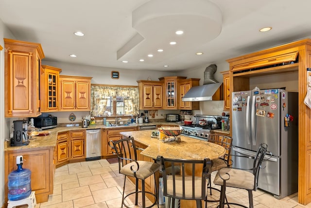 kitchen with ventilation hood, sink, appliances with stainless steel finishes, light tile patterned flooring, and light stone counters