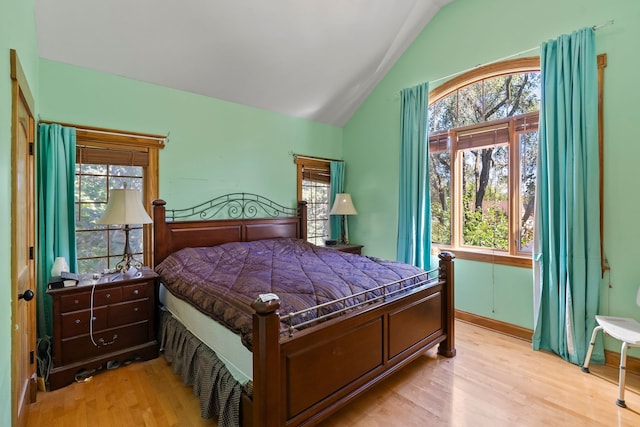 bedroom featuring light hardwood / wood-style floors and vaulted ceiling