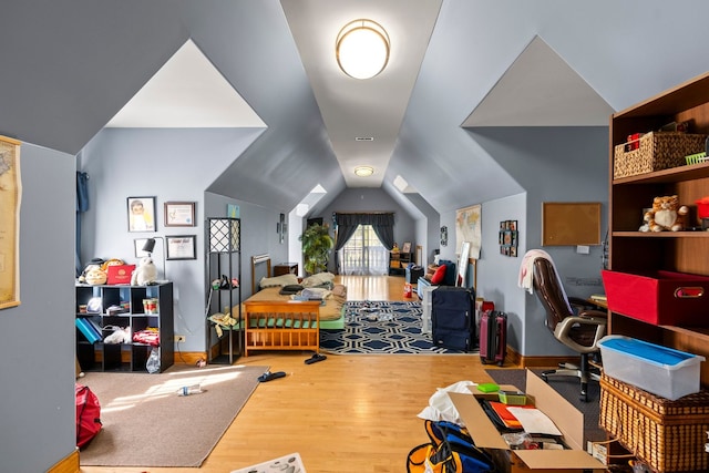 bedroom featuring lofted ceiling and wood-type flooring