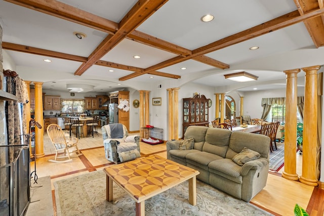 living room featuring beam ceiling, decorative columns, and coffered ceiling