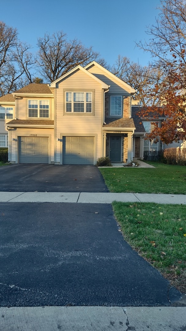 view of front facade with a front lawn and a garage