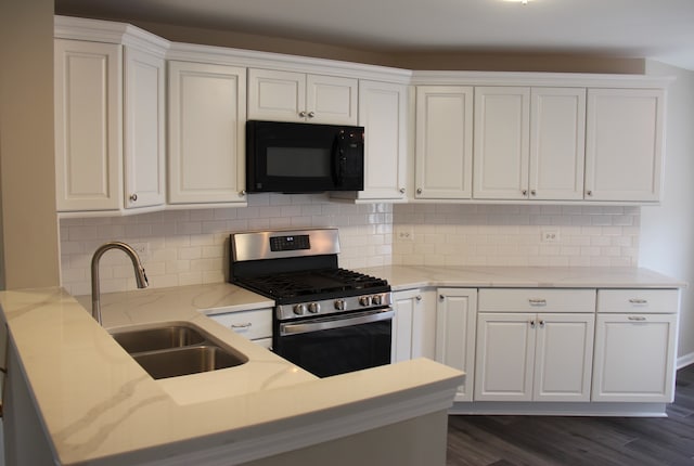 kitchen featuring white cabinets, stainless steel range with gas cooktop, sink, dark hardwood / wood-style floors, and tasteful backsplash