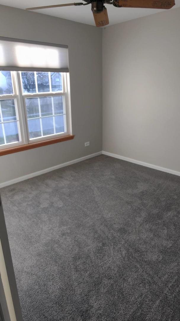 carpeted empty room with ceiling fan