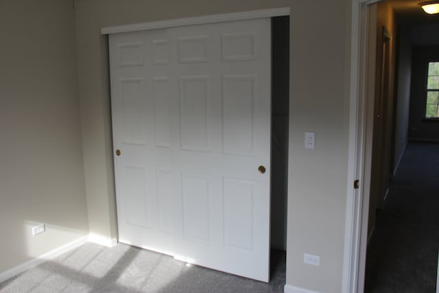 unfurnished bedroom with carpet and a closet